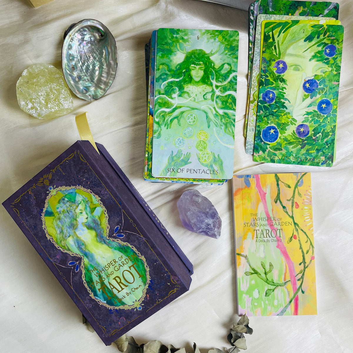 The Whisper of Stars and Garden Tarot card artwork and packaging