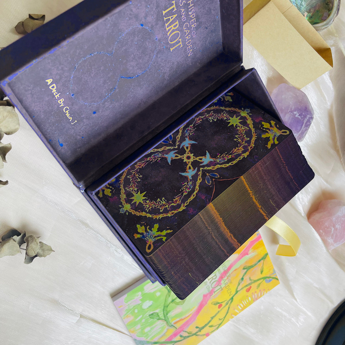 The Whisper of Stars and Garden Tarot product photo with illustrated cards and collector packaging